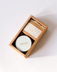 A gift set from Narra & Bee's 'Original Heritage Collection' in a brown kraft paper box, featuring a round white tin with a gold 'narra' logo and a wrapped bar of honey with a cream label.