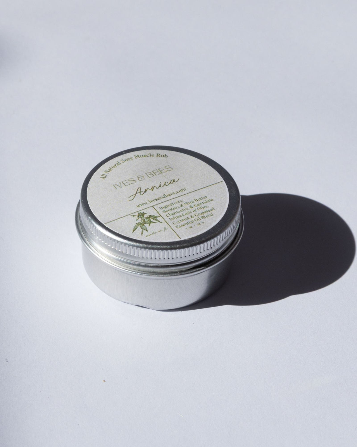 Arnica Salve with a lid on a white background