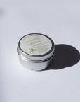 Arnica Salve with a lid on a white background
