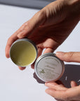 Person holdingArnica Salve