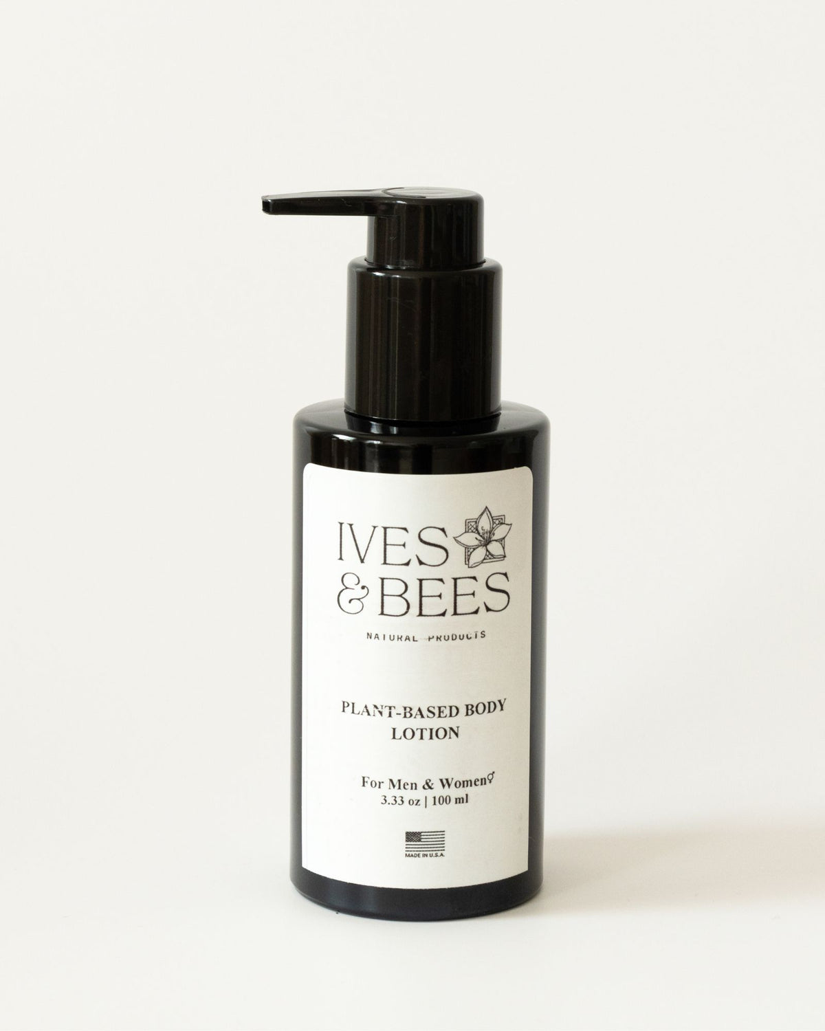 A bottle of Ives &amp; Bees Plant-Based Body Lotion with a black pump dispenser and a white label, set against a plain white background.