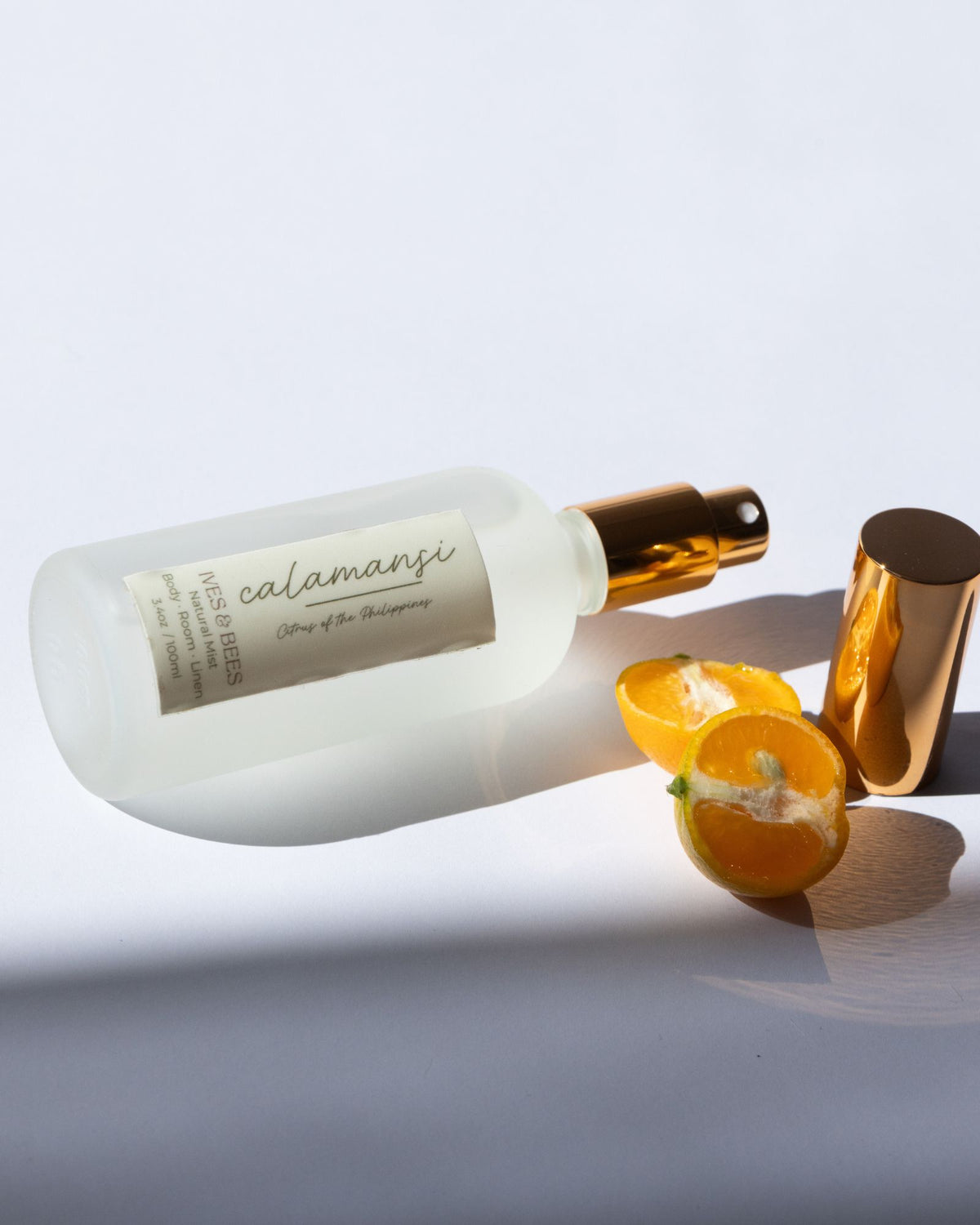 Handmade Natural Mist with gold cap and label on a light gray background