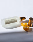 Handmade Natural Mist with gold cap and label on a light gray background