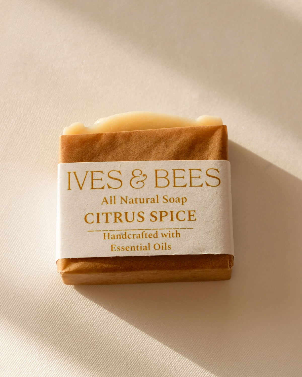 Handmade Citrus Spice Soap with 'Ives & Bees' branding on a beige background