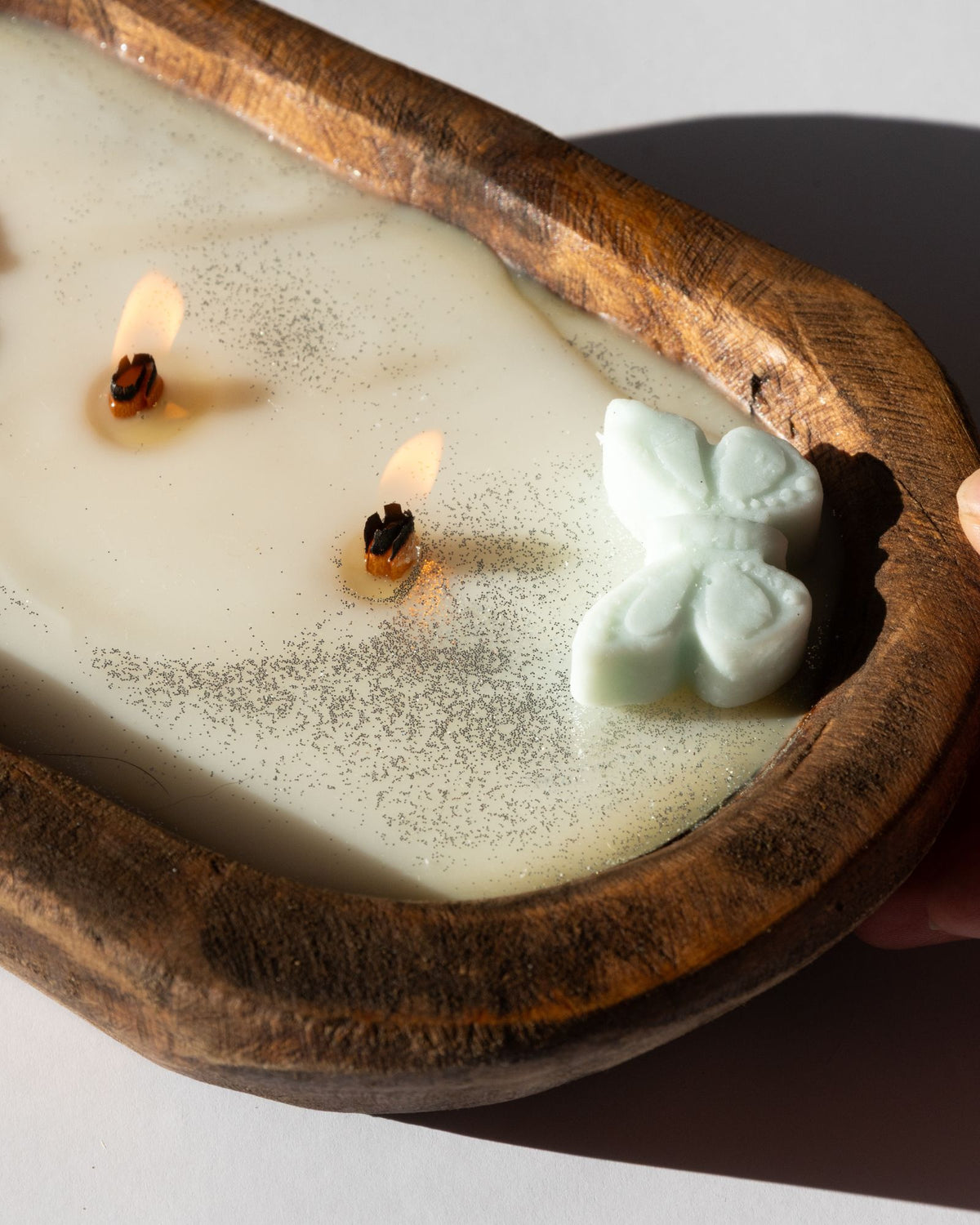 Diwata Wooden Bowl Candle with butterfly-shaped wick in a wooden holder