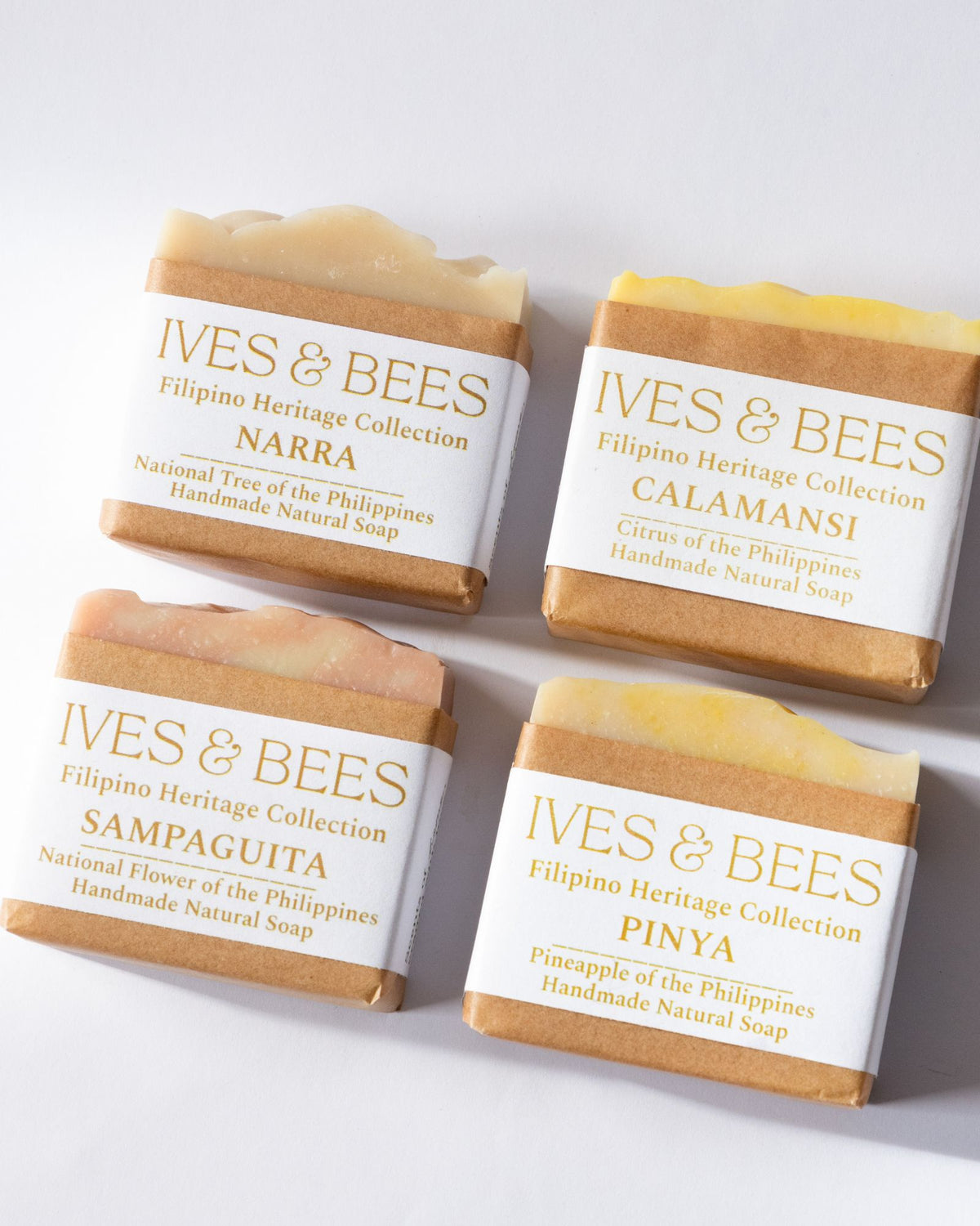 Handmade Four Ives & Bees natural soaps with different scents on a white background