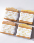 Handmade Four Ives & Bees natural soaps with different scents on a white background
