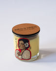 Maganda Ka Candle with a wooden lid featuring a design of a woman with a flower in her hair on a white background.