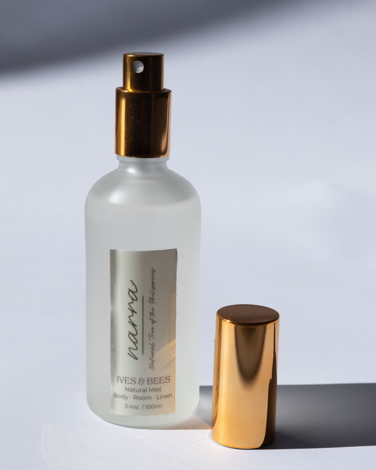 Handmade Natural Mist with gold nozzle on a light gray background