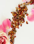 Dried flowers and pink rose petals on a white background