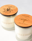 Sampaguita Candle & Narra Candle Duo with round engraved wooden lids, photographed on a clean white background. 
