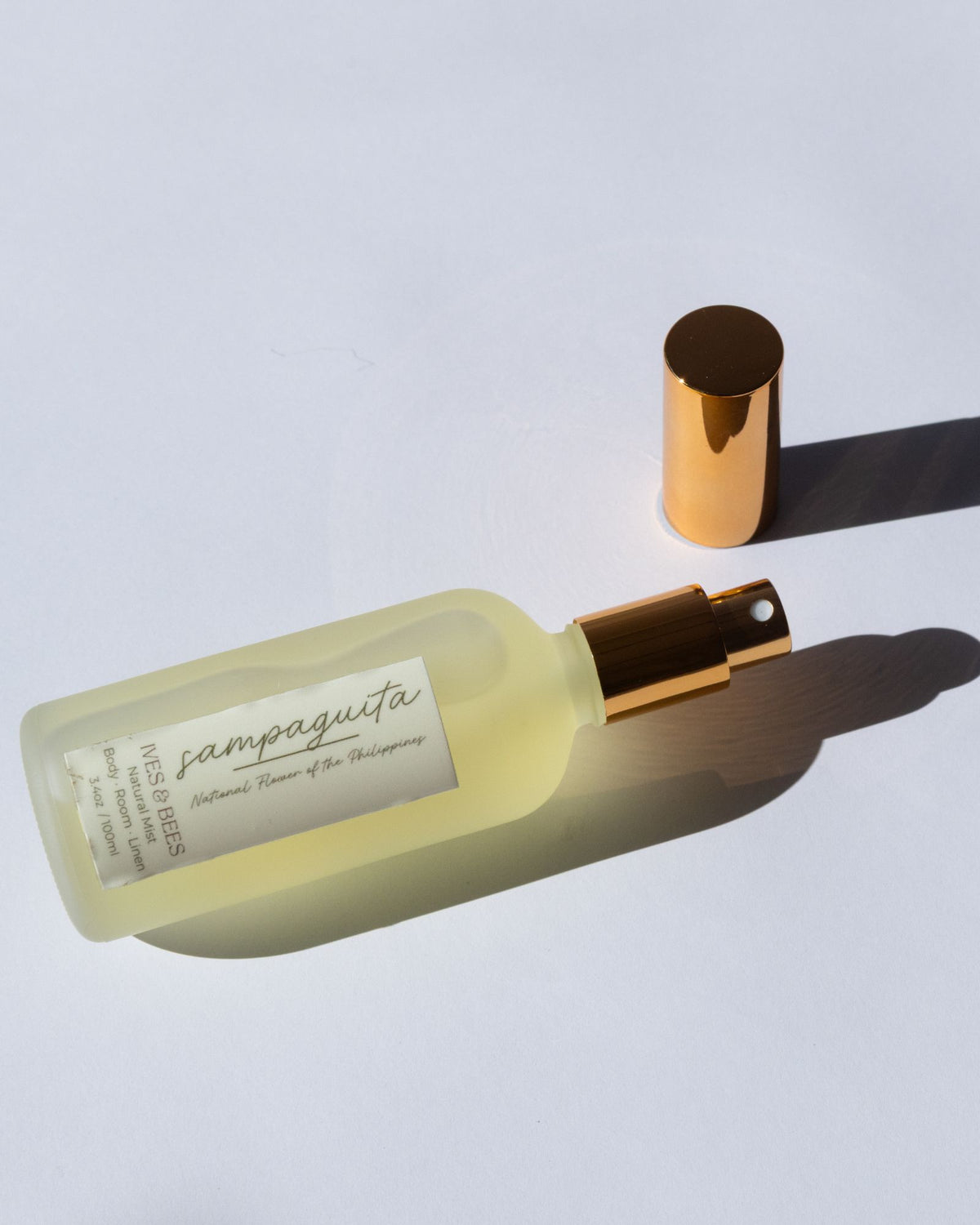 Handmade Natural Mist with gold cap on a light gray background